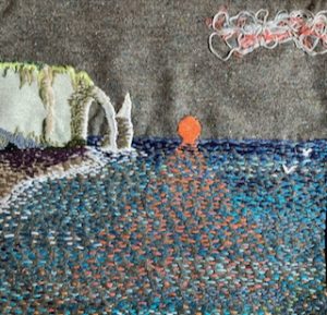 A cliff with sea and setting sun in a textile panel